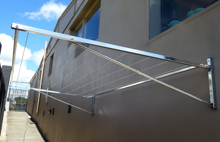 316 stainless steel clothesline mounted to rendered brick wall