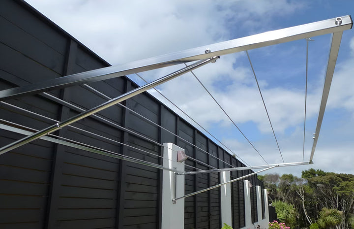 316 stainless steel clothesline wall mounted to fence with concrete posts - zoomed in, showing the arms and drying lines