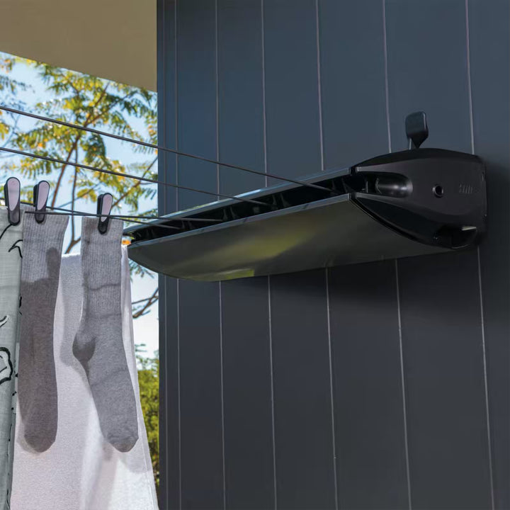 Hills 5 Line Retracting Clothesline  installed and in use outdoors drying wet laundry