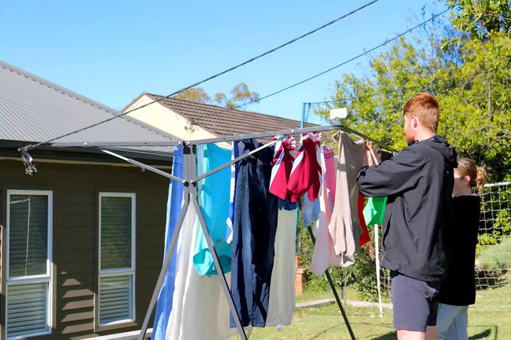 Sunchaser Mobile Clothesline with people hanging wet laundry